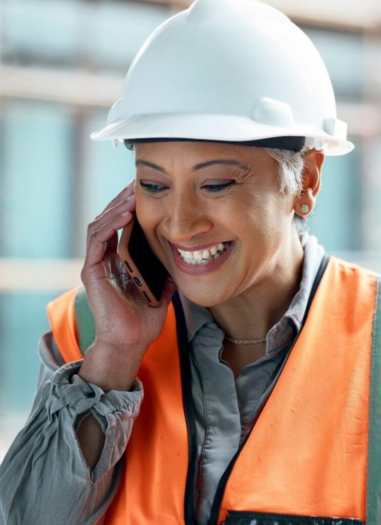 Construction site, contractor and happy woman developer phone call planning for logistics, industri