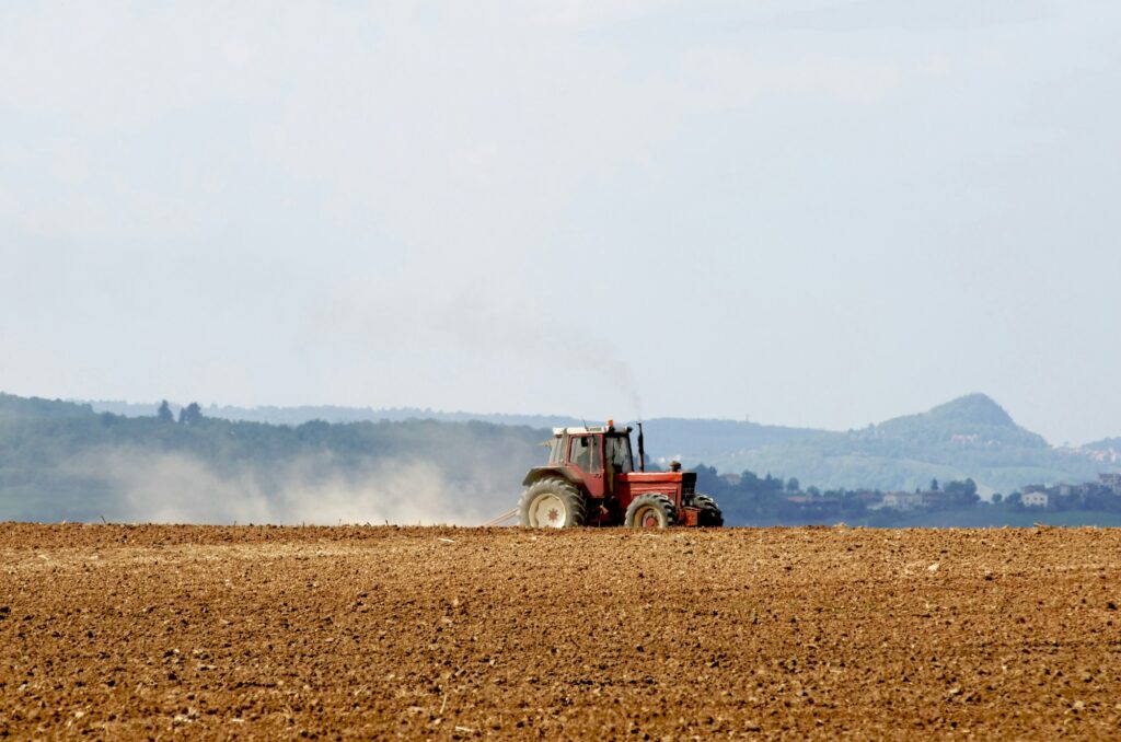 Tractor plowing field, Puy de Dome department, Auvergne-Rhone-Alpes, France